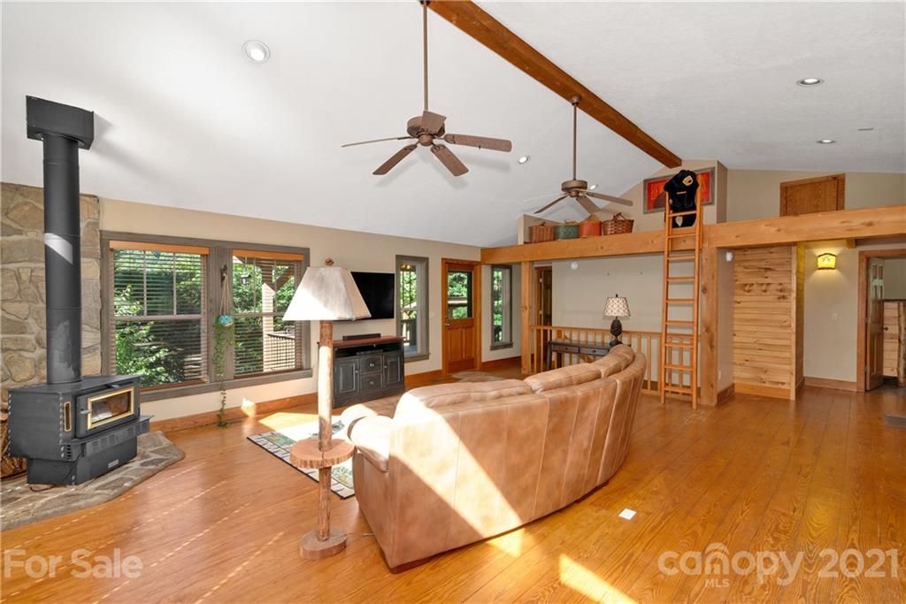 243 Rivermont Drive Canton, NC 28716 - Photo 5 of 29 a living room with furniture a flat screen tv and floor to ceiling window