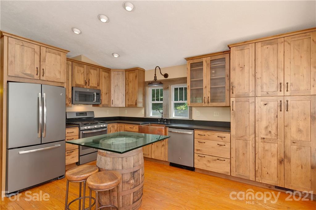 243 Rivermont Drive Canton, NC 28716 - Photo 6 of 29 a kitchen with stainless steel appliances granite countertop a stove a refrigerator a sink dishwasher with a dining table and chairs