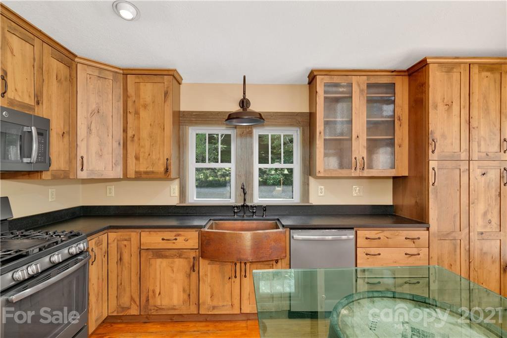 243 Rivermont Drive Canton, NC 28716 - Photo 7 of 29 a kitchen with a window and cabinets