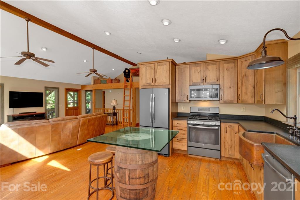 243 Rivermont Drive Canton, NC 28716 - Photo 8 of 29 a large kitchen with stainless steel appliances granite countertop a sink and a stove