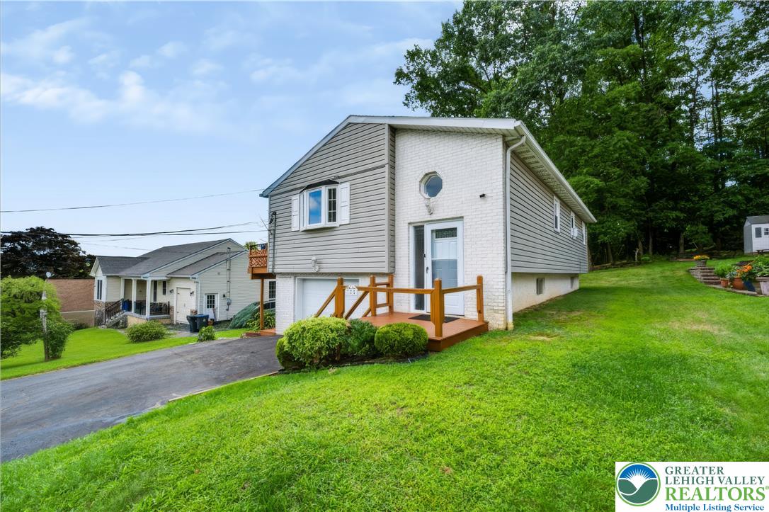 1764 Ritter Street Bethlehem, PA 18015 - Photo 1 of 29 An inviting exterior with a grassy slope and a classic wood entry deck.