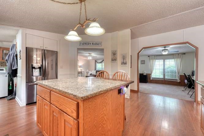 5359 Owltown Road Blairsville, GA 30512 - Photo 19 of 52 a kitchen with stainless steel appliances granite countertop a sink a refrigerator and a stove