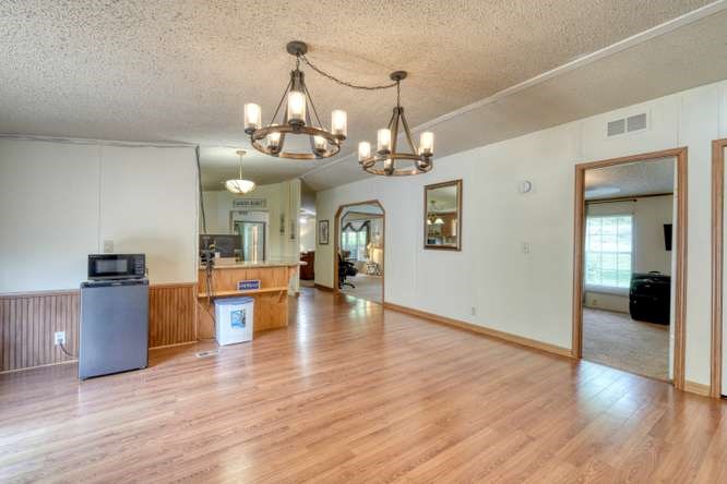 5359 Owltown Road Blairsville, GA 30512 - Photo 23 of 52 a view of a dining room with furniture and wooden floor
