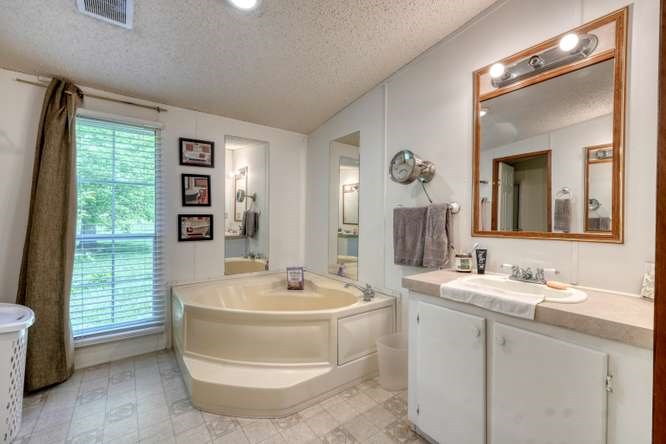 5359 Owltown Road Blairsville, GA 30512 - Photo 29 of 52 a bathroom with a double vanity sink and a mirror