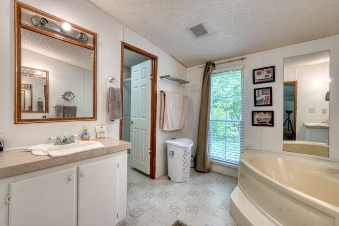 5359 Owltown Road Blairsville, GA 30512 - Photo 30 of 52 a spacious bathroom with a bathtub sink and mirror