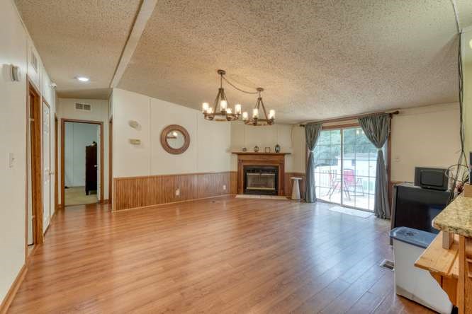 5359 Owltown Road Blairsville, GA 30512 - Photo 6 of 52 a view of an empty room with wooden floor and a large window