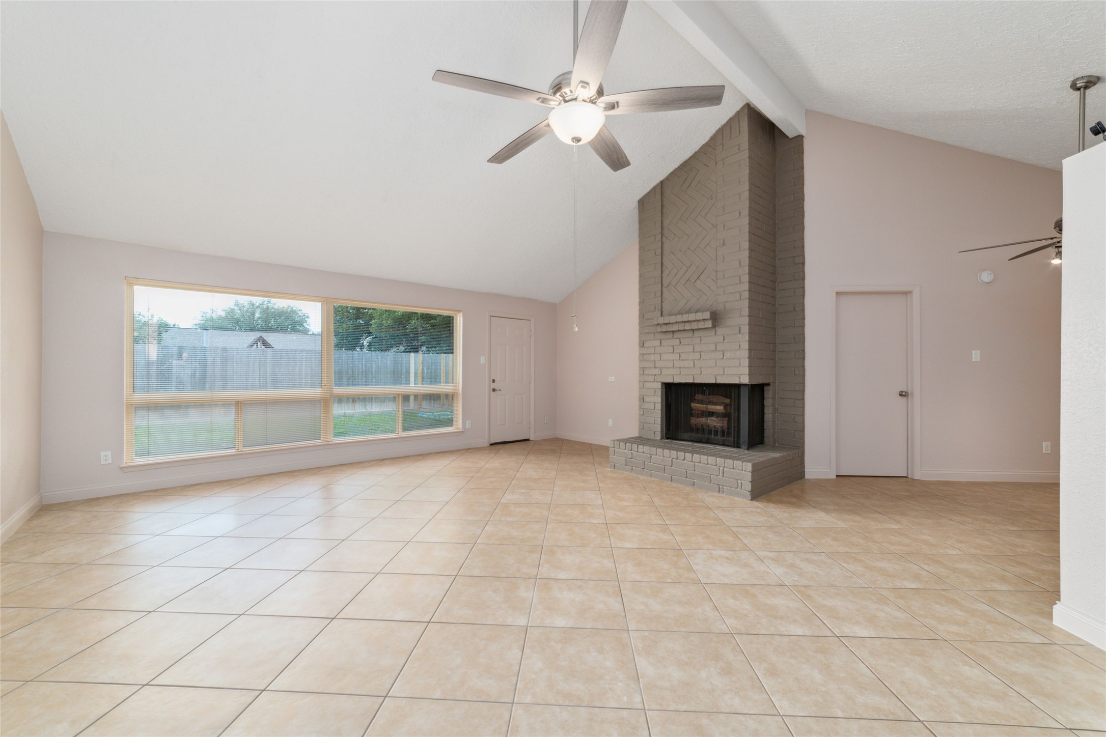 21603 Slippery Creek Lane Spring, TX 77388 - Photo 11 of 28 a view of an empty room with a fireplace and a window