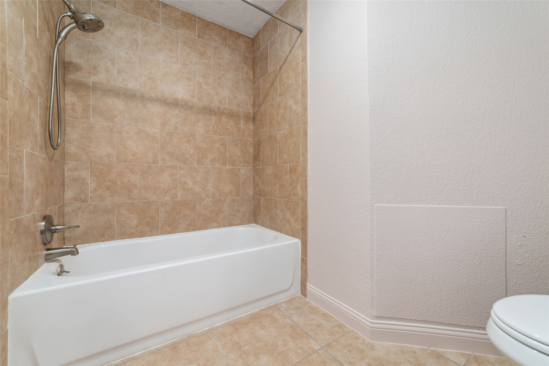 21603 Slippery Creek Lane Spring, TX 77388 - Photo 21 of 28 a bathroom with a bathtub and a toilet