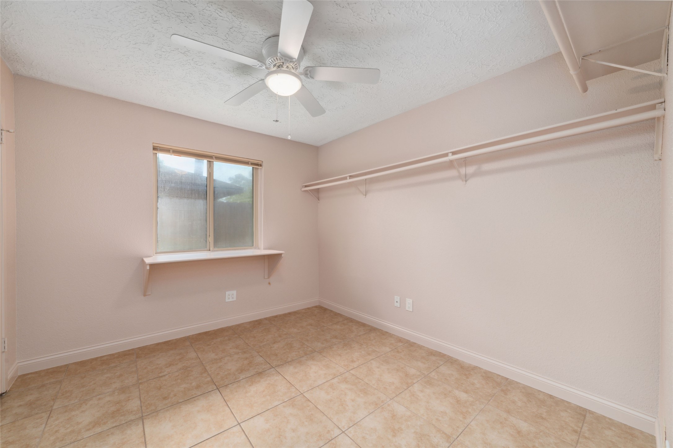 21603 Slippery Creek Lane Spring, TX 77388 - Photo 23 of 28 an empty room with a ceiling fan and a window