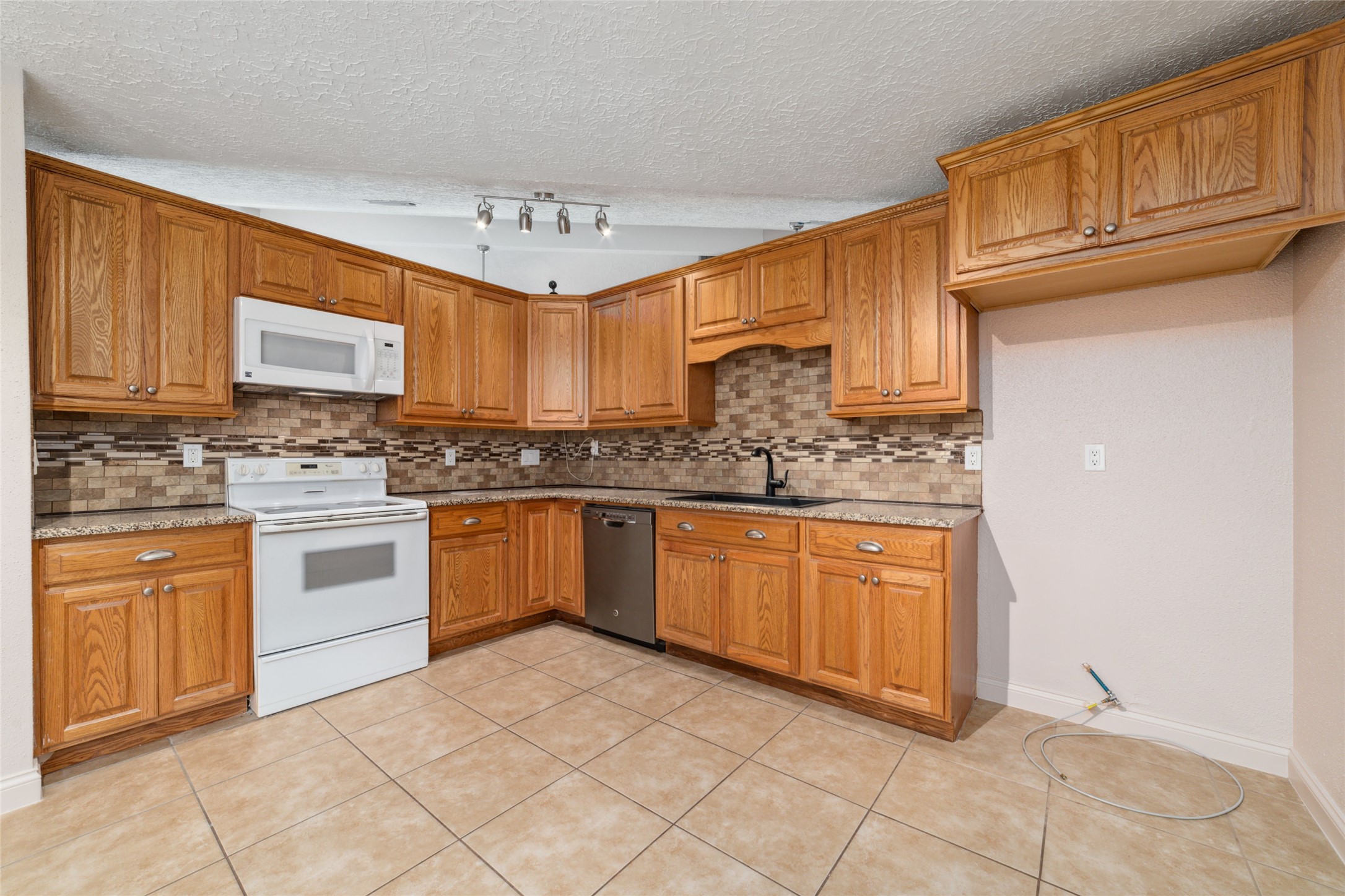 21603 Slippery Creek Lane Spring, TX 77388 - Photo 5 of 28 a kitchen with stainless steel appliances granite countertop a stove sink and cabinets
