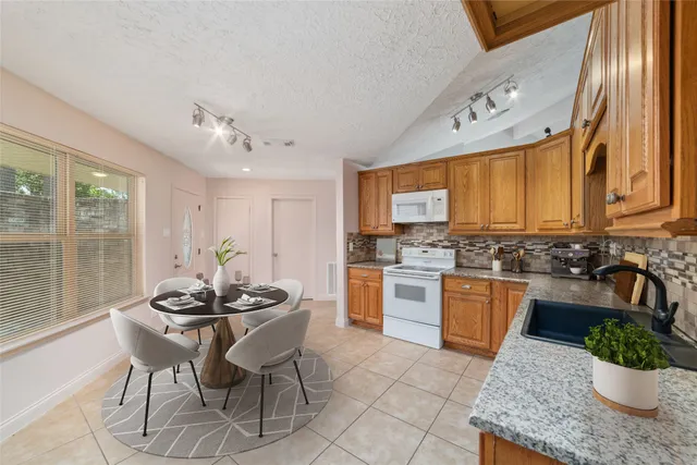 a kitchen with a stove a sink and a refrigerator