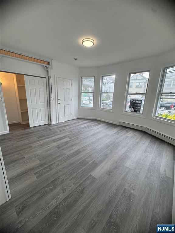 71-73 Madison Avenue, Unit 1 Paterson, NJ 07524 - Photo 2 of 7 an empty room with wooden floor and windows