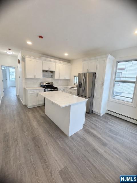 71-73 Madison Avenue, Unit 1 Paterson, NJ 07524 - Photo 3 of 7 a large kitchen with a white stove top oven and refrigerator