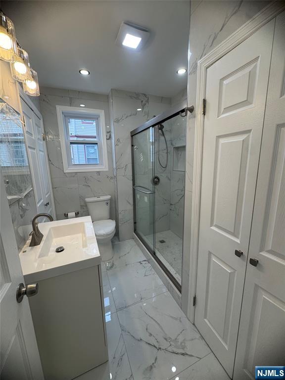 71-73 Madison Avenue, Unit 1 Paterson, NJ 07524 - Photo 5 of 7 a bathroom with a shower a sink and a toilet