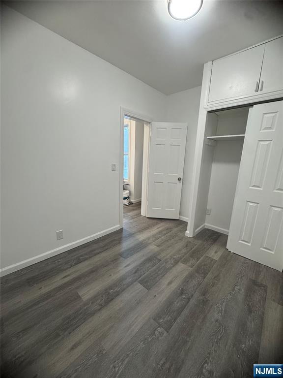 71-73 Madison Avenue, Unit 1 Paterson, NJ 07524 - Photo 6 of 7 an empty room with wooden floor & cabinet and windows