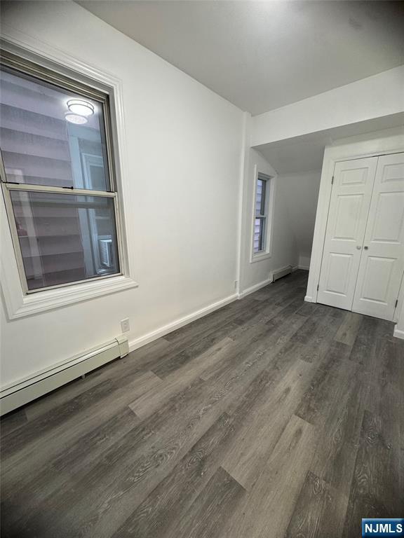 71-73 Madison Avenue, Unit 1 Paterson, NJ 07524 - Photo 7 of 7 an empty room with wooden floor and mirror
