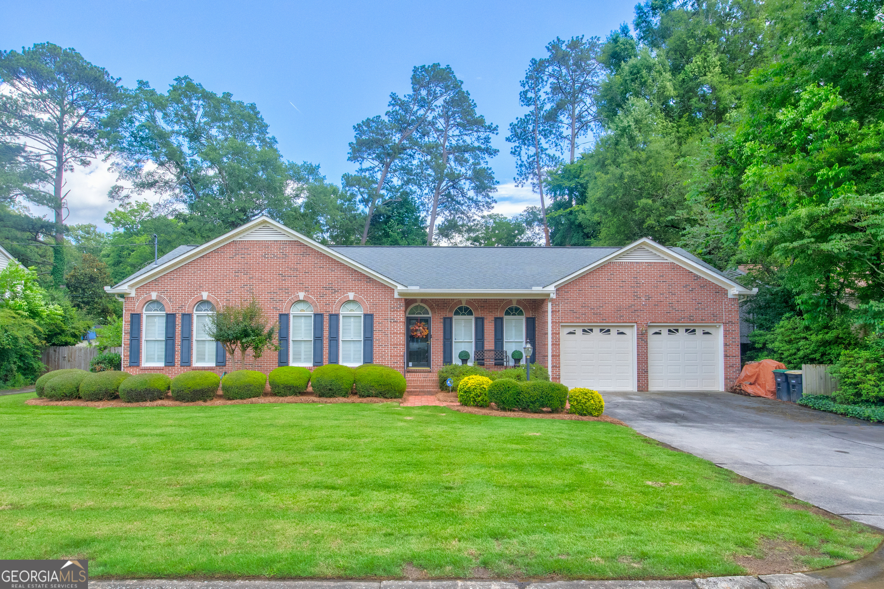 a front view of house with yard and green space