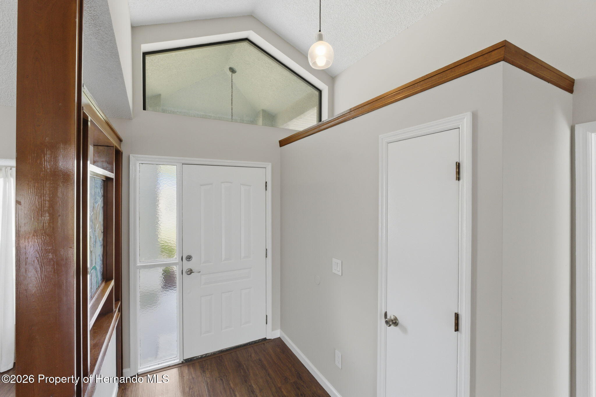 4966 Keysville Avenue Spring Hill, FL 34608 - Photo 6 of 50 a view of a hallway with wooden floor and entryway