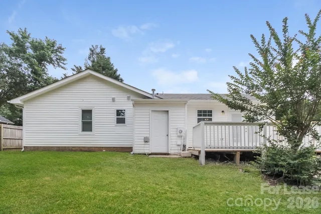 a view of backyard of house and deck