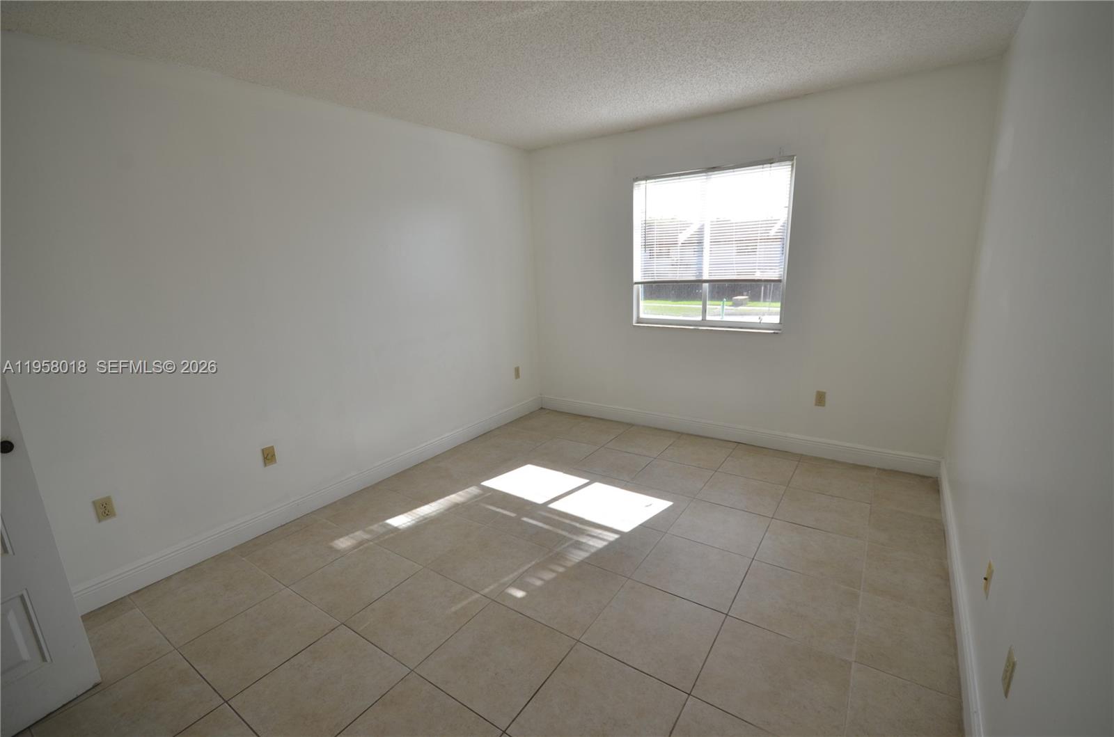 15201 Southwest 80th Street, Unit 207 Miami, FL 33193 - Photo 6 of 19 an empty room with a window