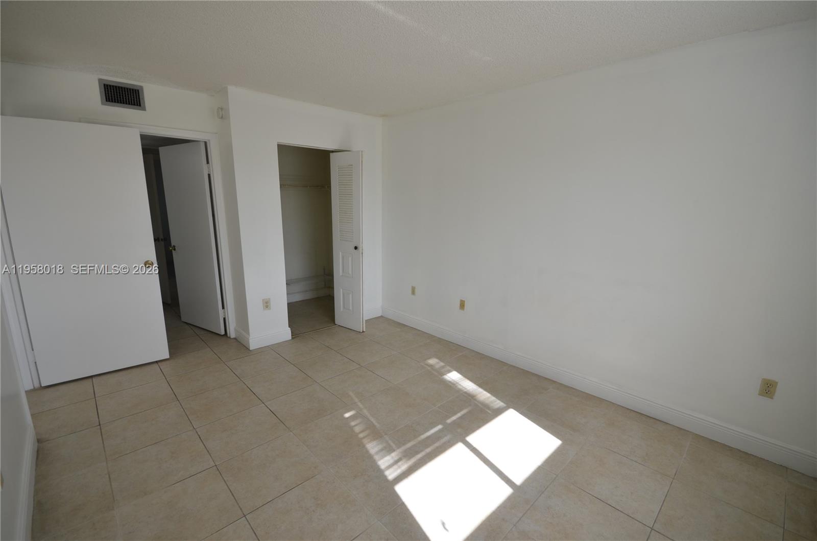 15201 Southwest 80th Street, Unit 207 Miami, FL 33193 - Photo 7 of 19 a view of an empty room and window