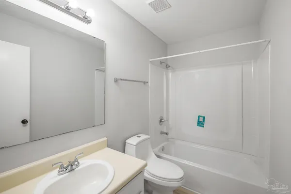 a bathroom with a toilet a sink and bathtub