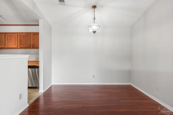 a view of a room with wooden floor and a window