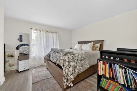 a bedroom with a bed and a book shelf