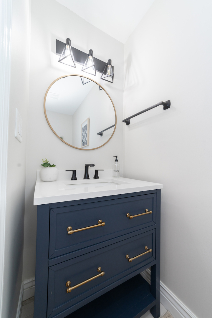 4818 5th Street Winthrop Harbor, IL 60096 - Photo 13 of 42 a bathroom with a sink mirror and vanity