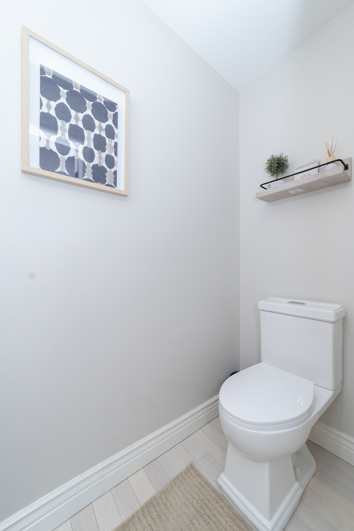 4818 5th Street Winthrop Harbor, IL 60096 - Photo 14 of 42 a white toilet sitting next to a white wall