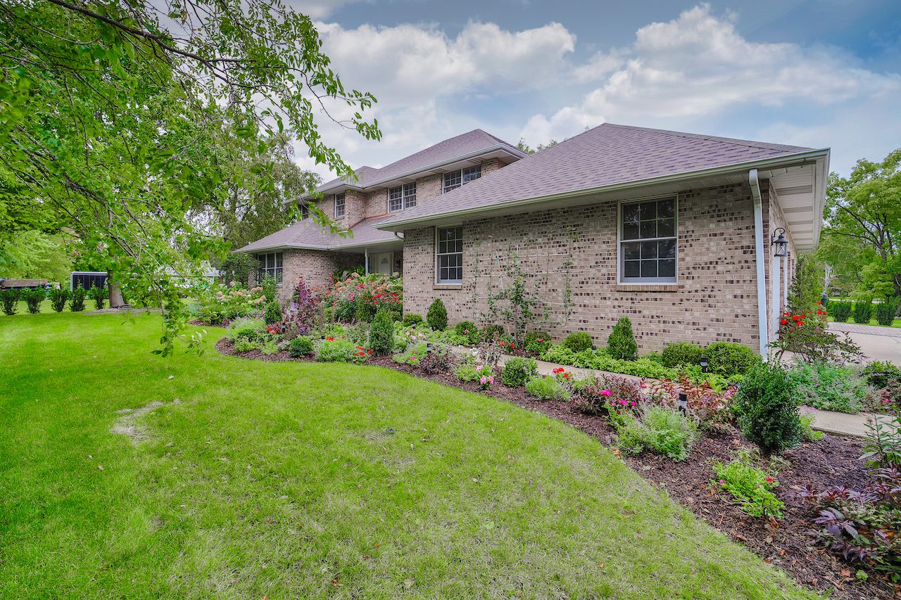 4818 5th Street Winthrop Harbor, IL 60096 - Photo 2 of 42 a front view of a house with a garden