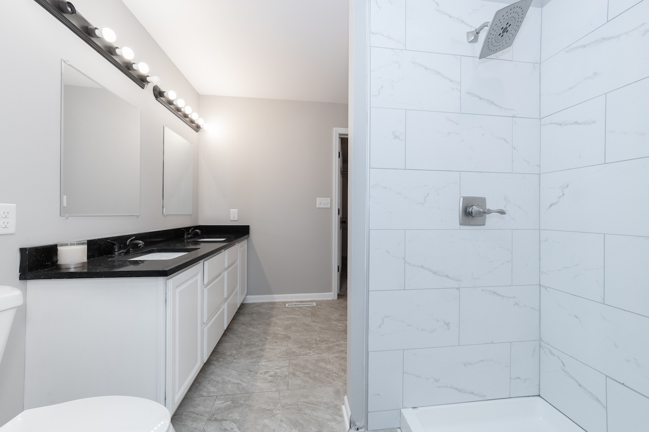 4818 5th Street Winthrop Harbor, IL 60096 - Photo 21 of 42 a kitchen with granite countertop a sink and a stove top oven
