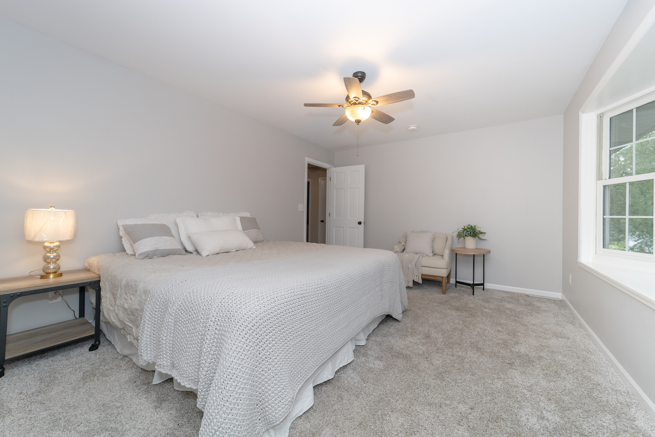 4818 5th Street Winthrop Harbor, IL 60096 - Photo 22 of 42 a bedroom with a bed and a chandelier