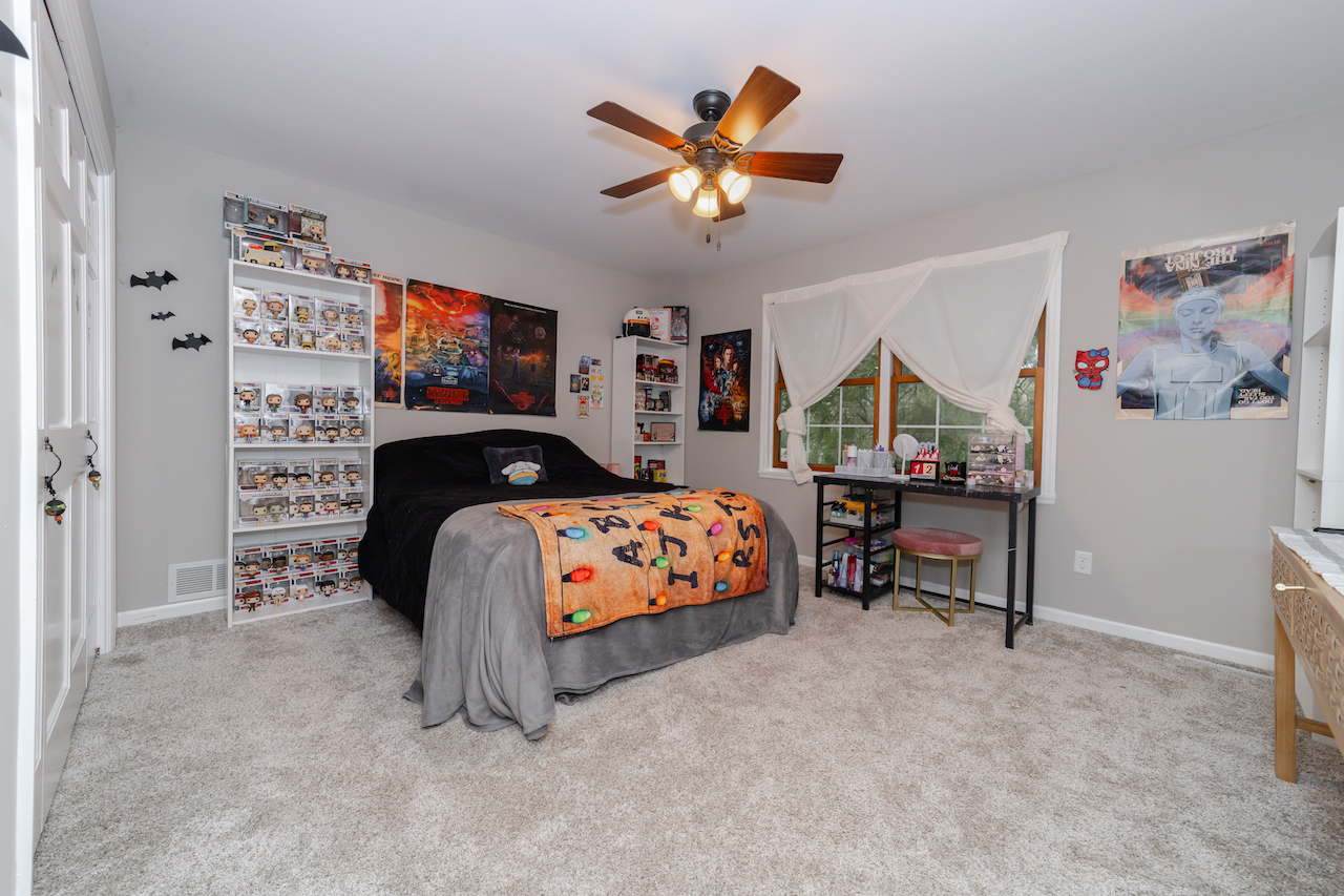 4818 5th Street Winthrop Harbor, IL 60096 - Photo 25 of 42 a bedroom with a bed and a chandelier