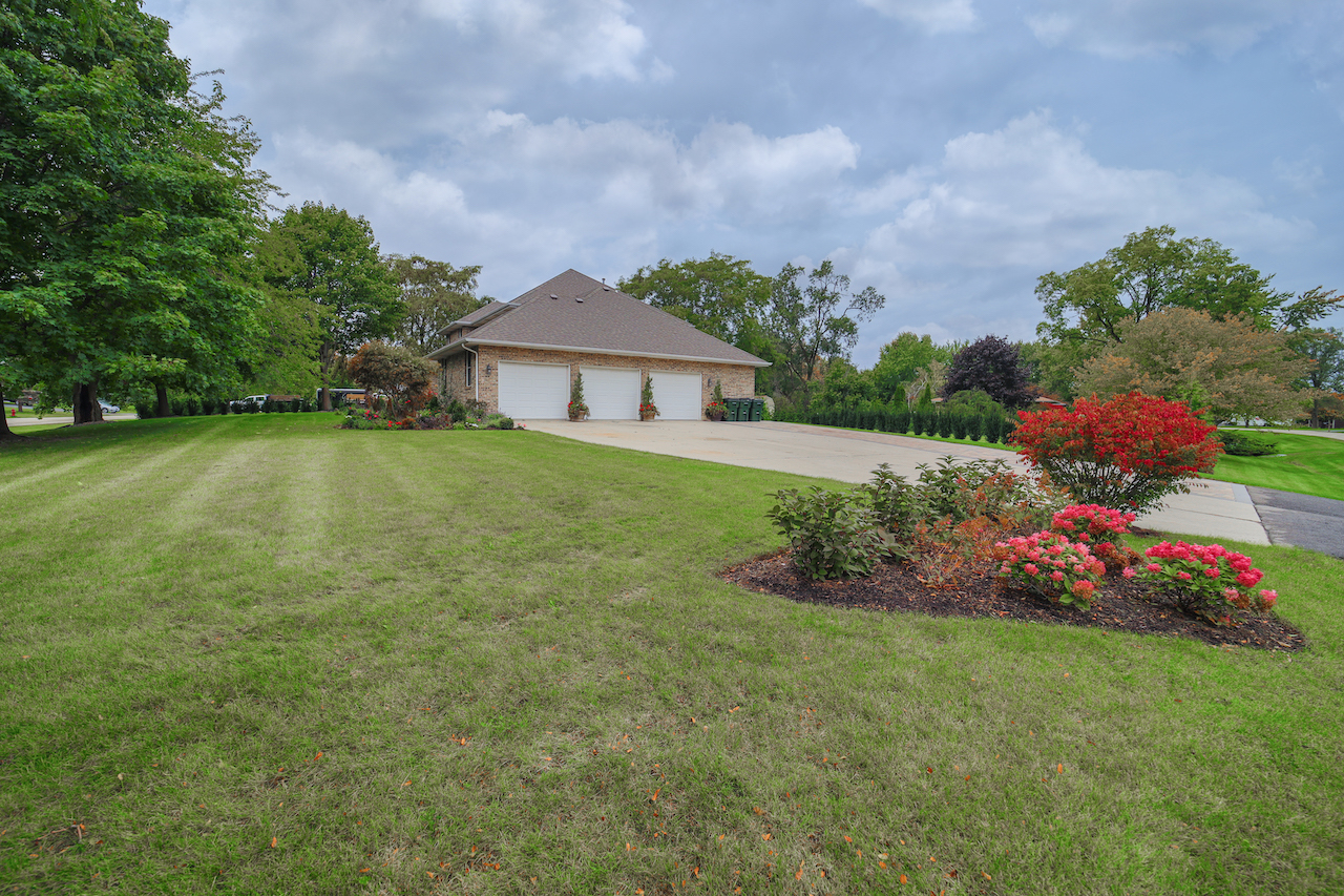 4818 5th Street Winthrop Harbor, IL 60096 - Photo 3 of 42 a view of a house with a big yard and potted plants