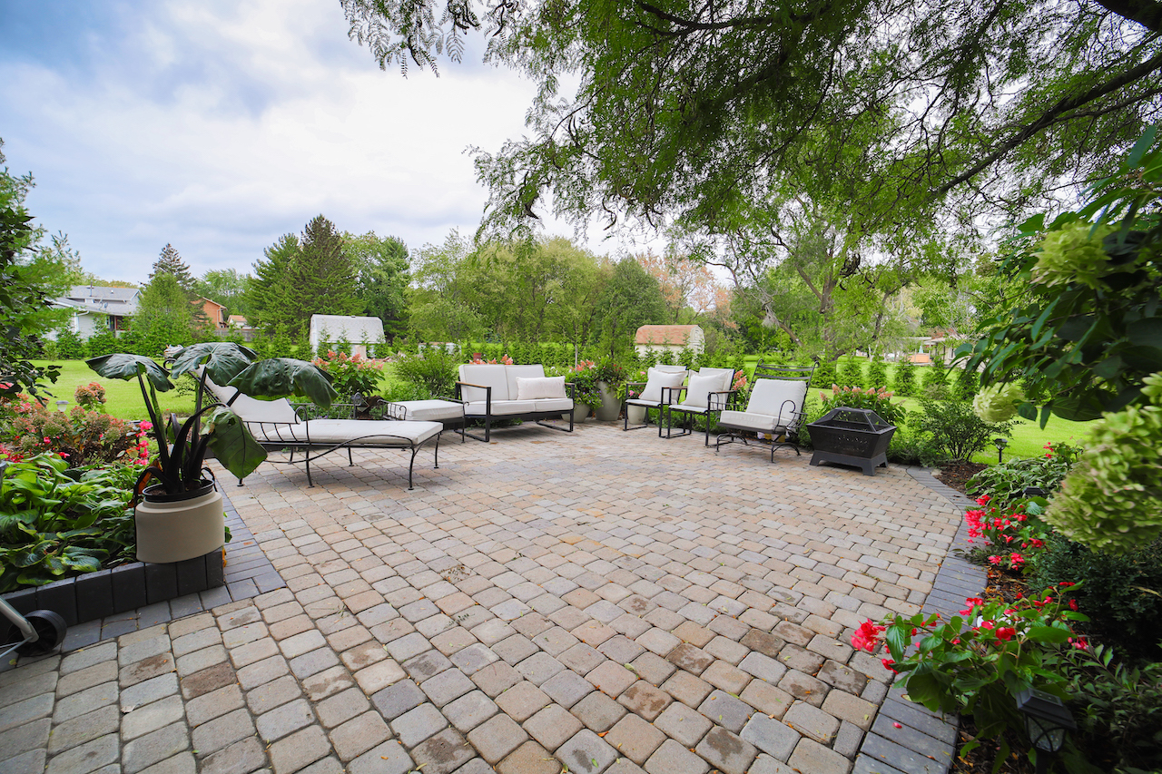 4818 5th Street Winthrop Harbor, IL 60096 - Photo 32 of 42 a view of a patio with table and chairs potted plants and a large tree