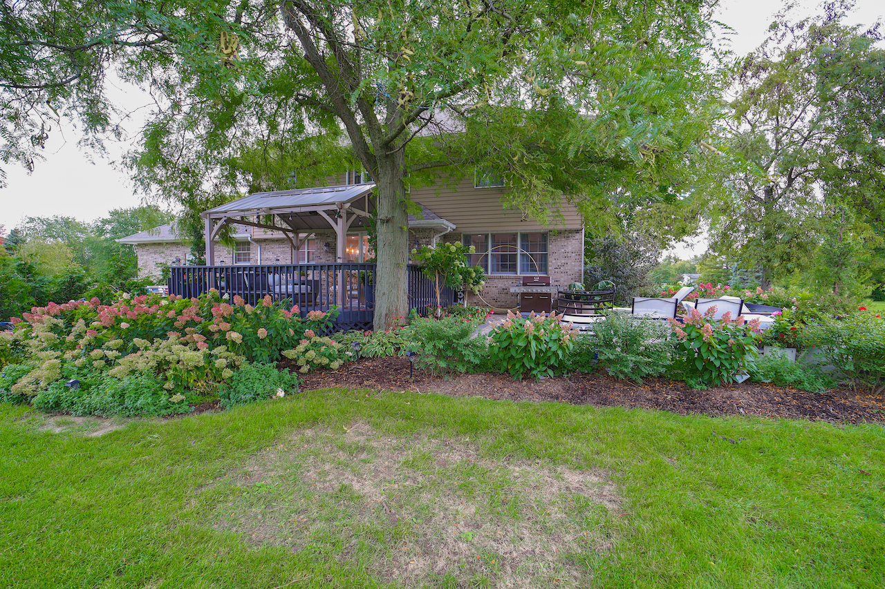 4818 5th Street Winthrop Harbor, IL 60096 - Photo 33 of 42 a front view of a house with a garden and trees