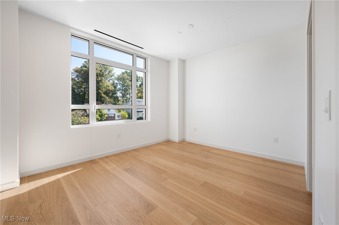 22700 Lake Road, Unit 204 Rocky River, OH 44116 - Photo 19 of 31 Empty room featuring light wood-style floors and baseboards