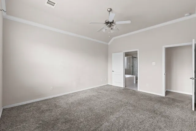 a view of an empty room with a chandelier fan