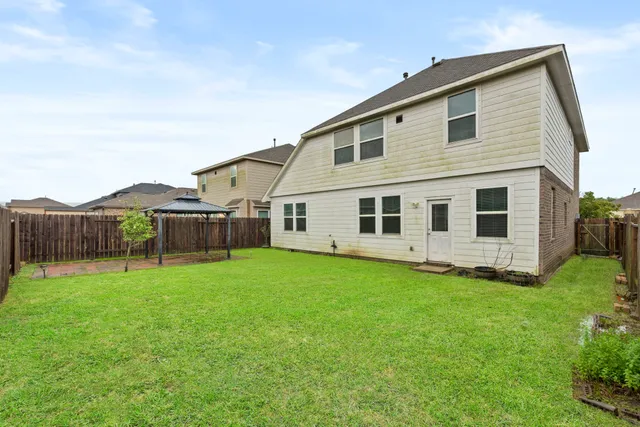 a backyard of a house with wooden fence