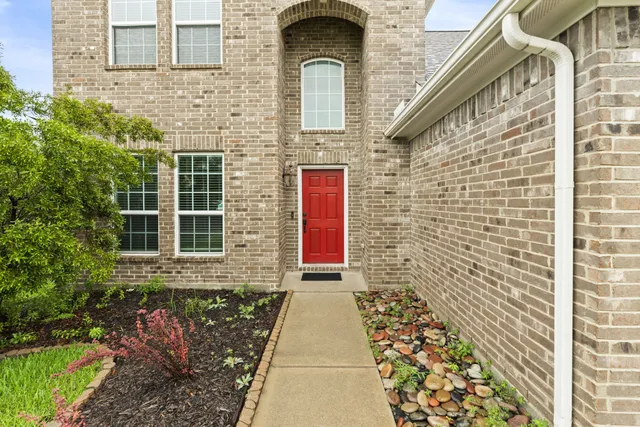 a view of a brick house with many windows