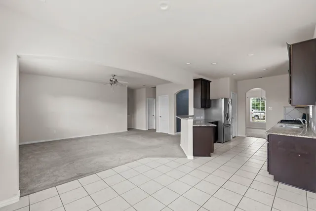 a kitchen with stainless steel appliances granite countertop a stove top oven microwave and cabinets