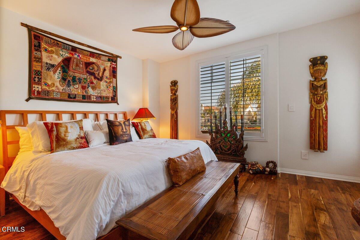 4322 Tradewinds Drive Oxnard, CA 93035 - Photo 13 of 30 a bedroom with a bed and wooden floor