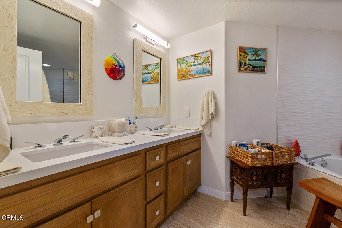 4322 Tradewinds Drive Oxnard, CA 93035 - Photo 15 of 30 a bathroom with a granite countertop sink and a mirror