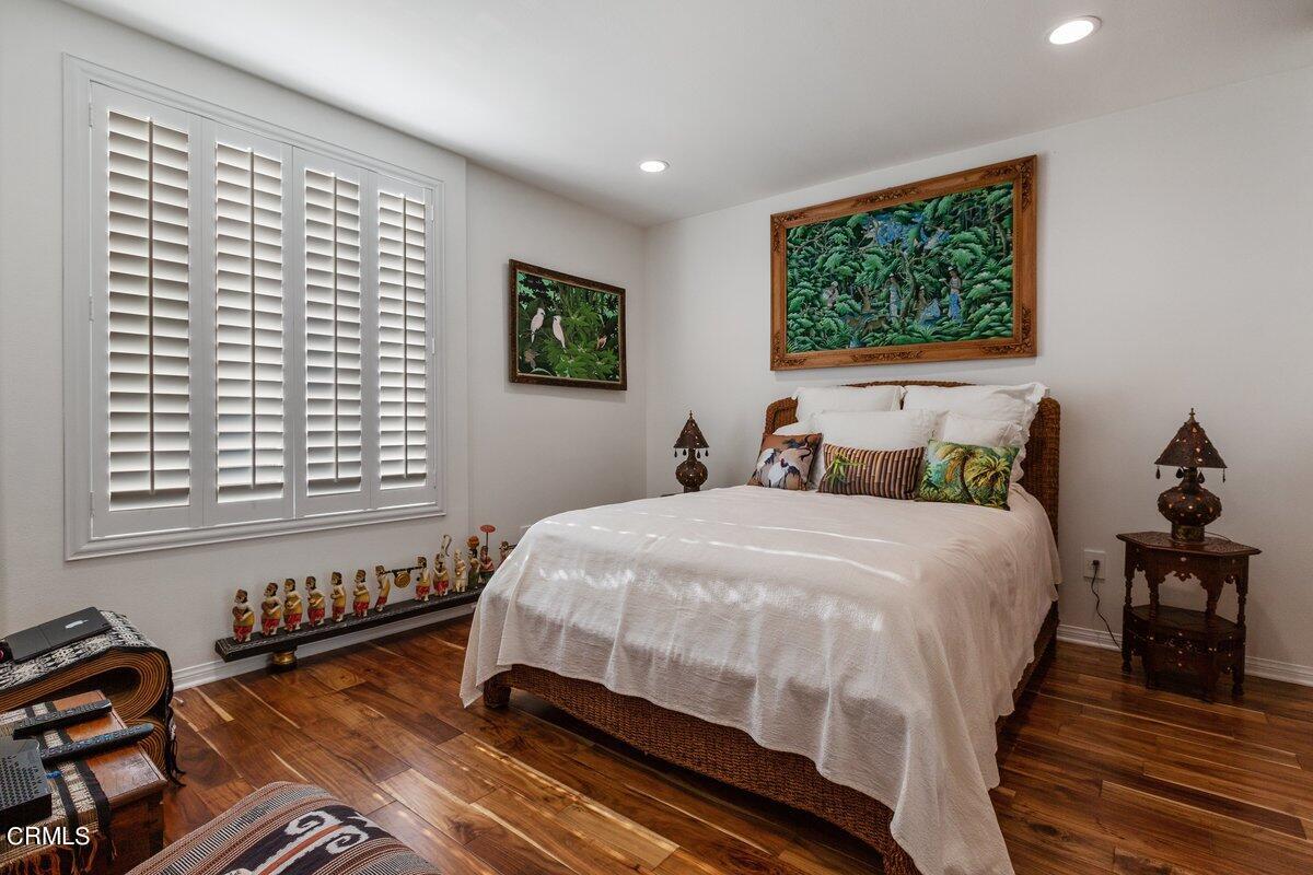 4322 Tradewinds Drive Oxnard, CA 93035 - Photo 17 of 30 a bedroom with a bed and wooden floor