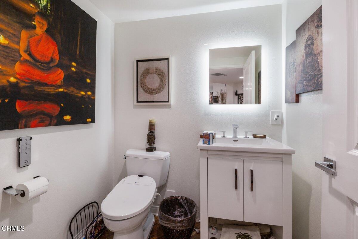 4322 Tradewinds Drive Oxnard, CA 93035 - Photo 20 of 30 a bathroom with a toilet a sink and mirror