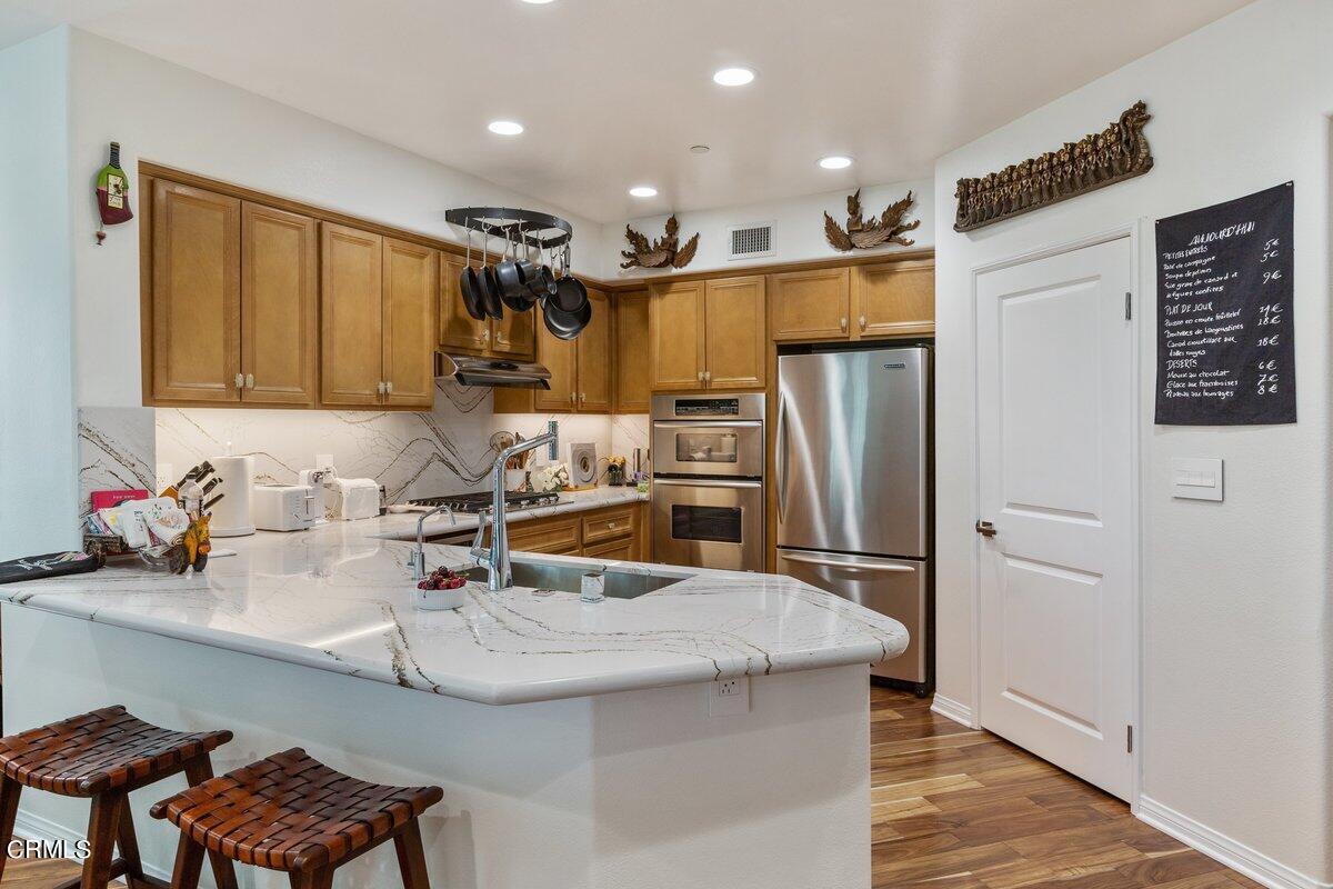 4322 Tradewinds Drive Oxnard, CA 93035 - Photo 10 of 30 a kitchen with refrigerator and chairs