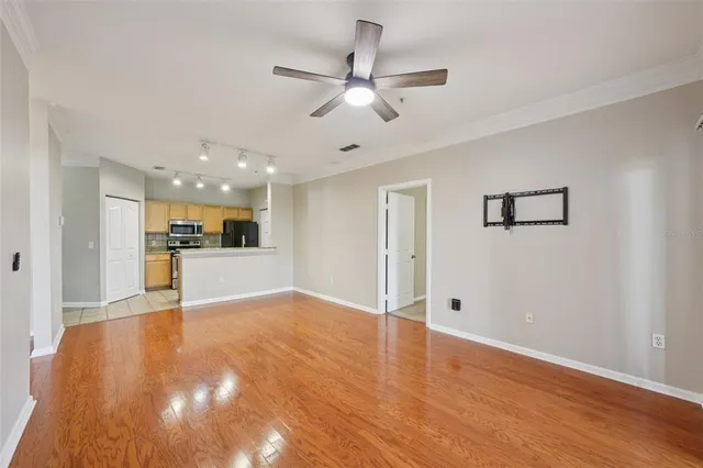 a kitchen with a sink a stove a refrigerator a microwave oven and a window