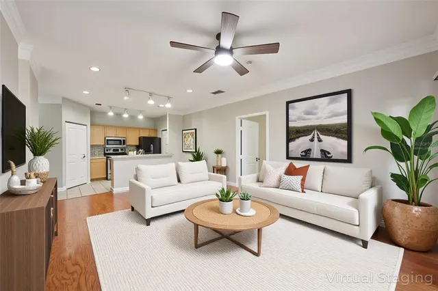 a view of kitchen with stainless steel appliances granite countertop a refrigerator a sink and a stove with wooden floor