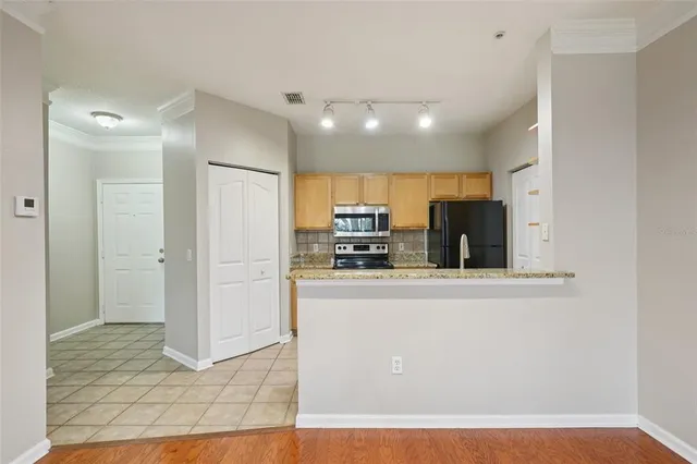 a kitchen with stainless steel appliances granite countertop a refrigerator and a stove
